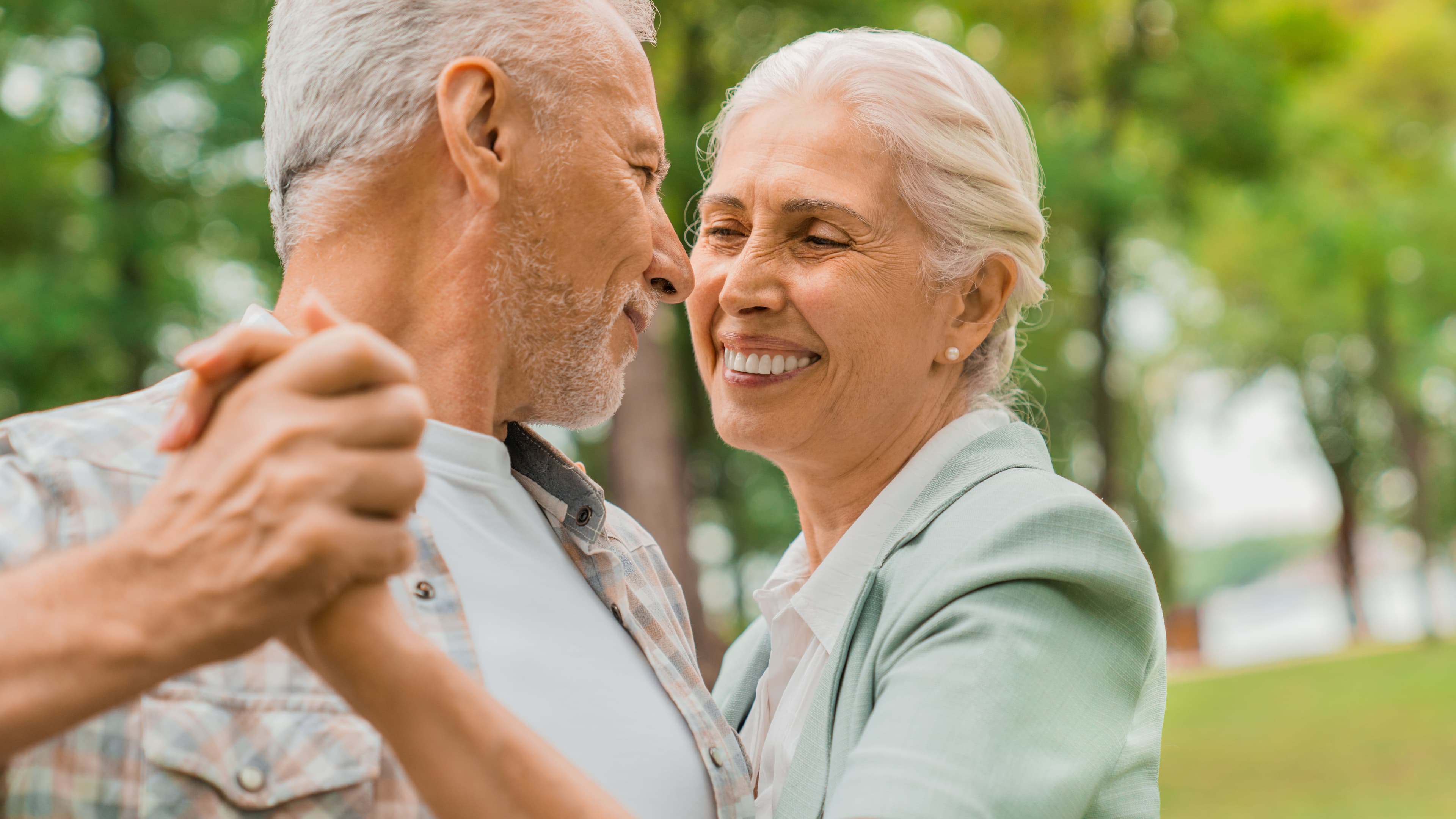 An older couple laughing together outdoors
